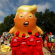 Demonstrators stand in front of a blimp portraying U.S. President Donald Trump, in Parliament Square, during the visit by Trump and First Lady Melania Trump in London